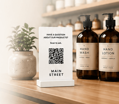A Main Street QR sign on a shelf next to store products